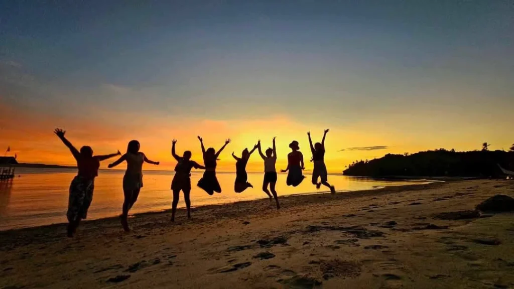 Happy guests jumping on the beach at Dreamshore Kiwi Beach Resort, Tablas Island Romblon